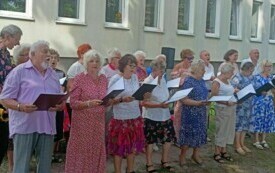 Uczestnicy Dziennego Domu Pomocy Społecznej w trakcie występu artystycznego przed siedzibą Centrum Usług Społecznych